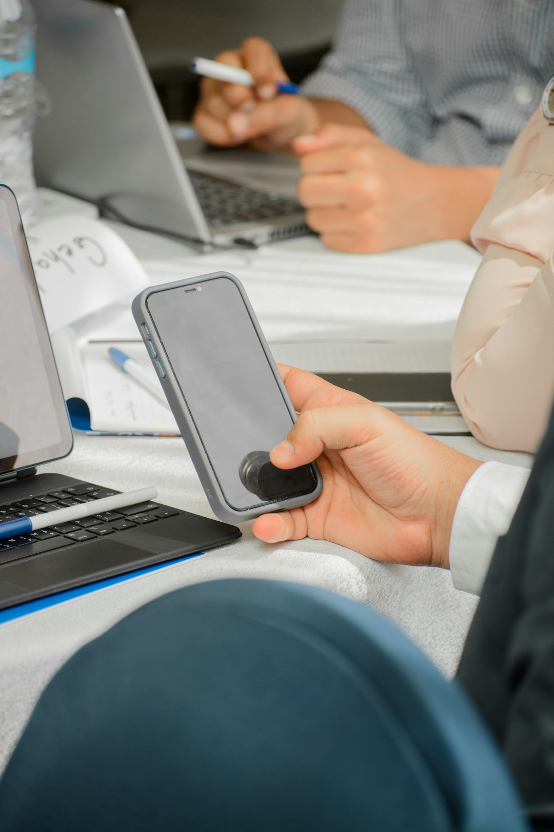 Services a-person-holding-a-cell-phone-in-front-of-a-laptop-8aru45ogkdm