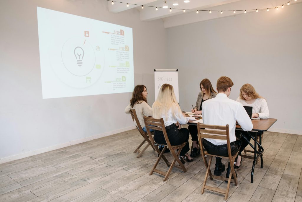 Services Group of young professionals collaborating in a bright office setting.
